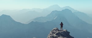 Backpacker standing on mountaintop
