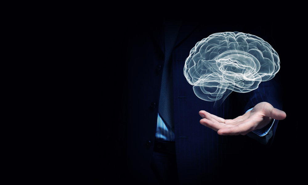 Close up of businessman hand holding brain in palm-2